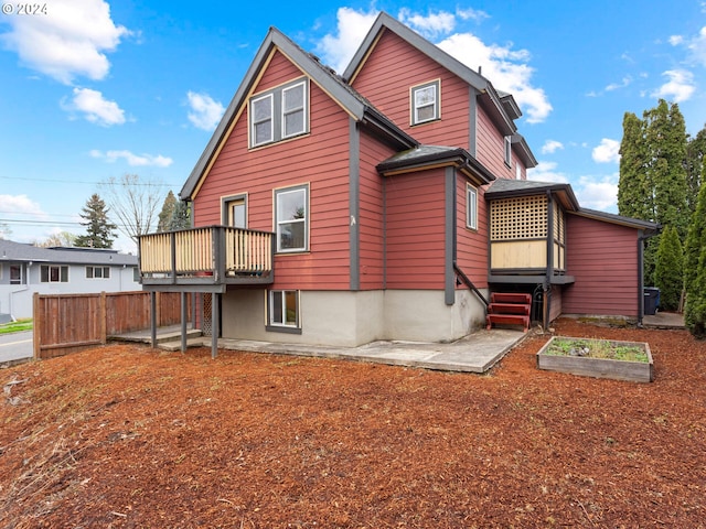 back of property with a patio area, a garden, and fence