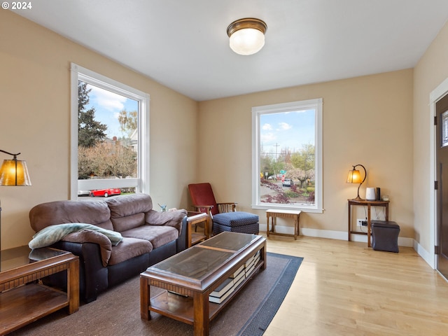 living room featuring baseboards and light wood-style floors