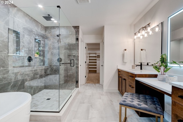 bathroom featuring vanity and shower with separate bathtub