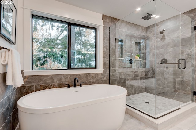 bathroom with plus walk in shower and tile walls