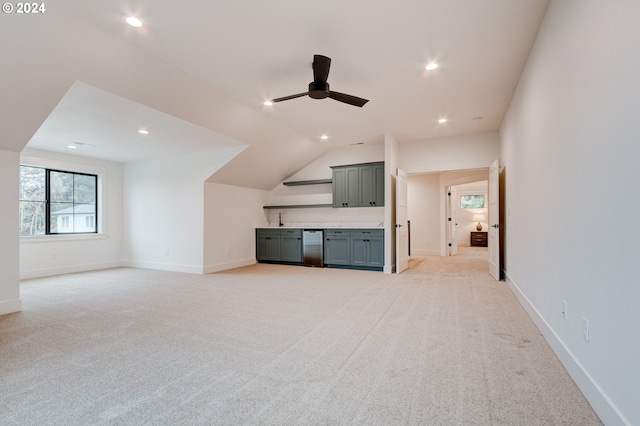 unfurnished living room with lofted ceiling, sink, light colored carpet, and ceiling fan