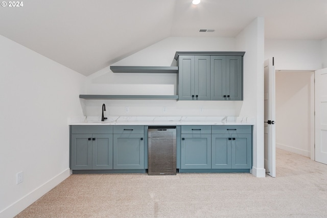 bar featuring light colored carpet, lofted ceiling, and sink