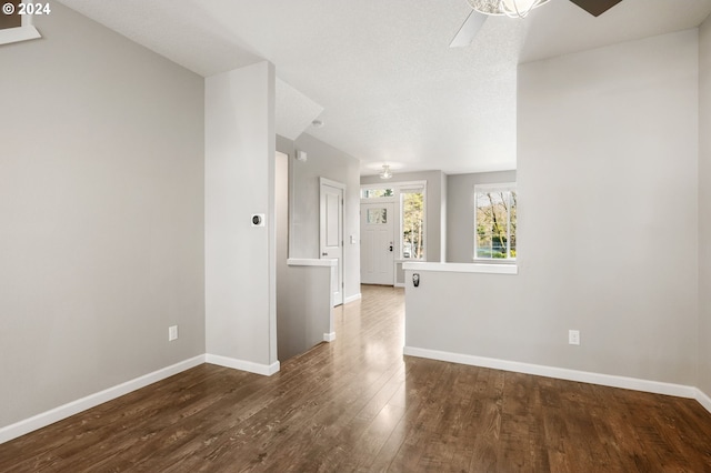 empty room with hardwood / wood-style flooring, ceiling fan, and a textured ceiling