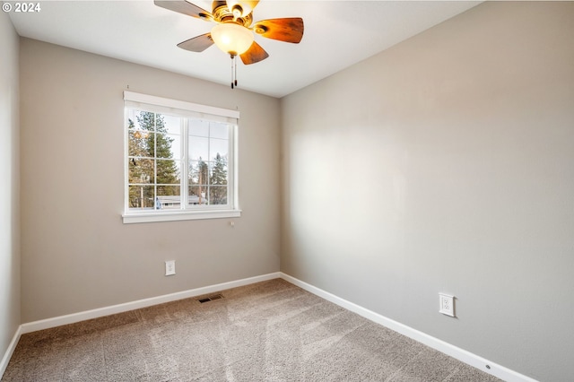 carpeted spare room with ceiling fan