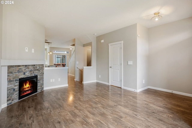 unfurnished living room featuring a fireplace and wood-type flooring