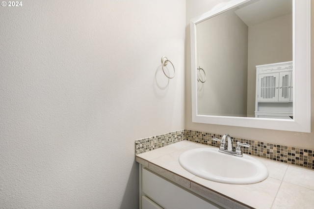 bathroom featuring vanity and backsplash