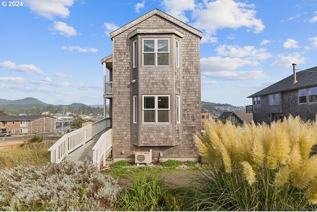 exterior space with a mountain view and ac unit
