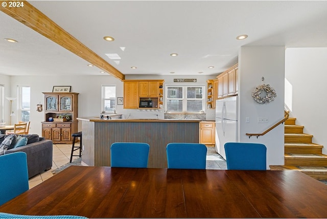 dining space with recessed lighting, stairway, beam ceiling, and light tile patterned flooring