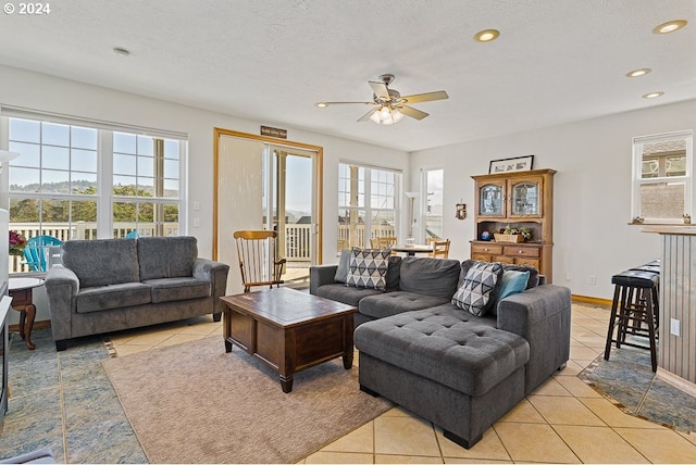 living area with light tile patterned flooring, a ceiling fan, and recessed lighting