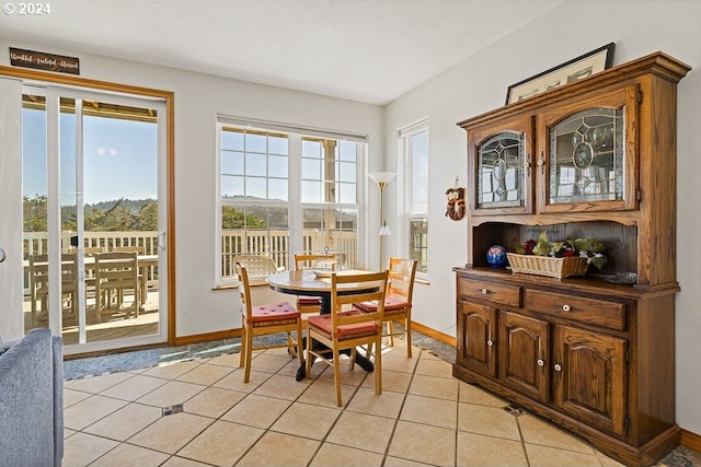 tiled dining area featuring a textured ceiling