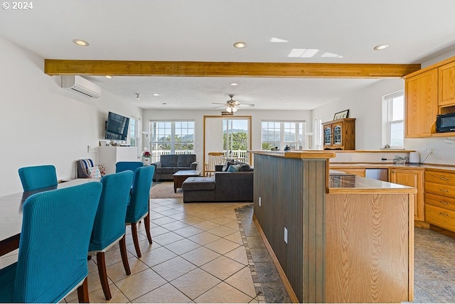 kitchen featuring beamed ceiling, ceiling fan, stainless steel dishwasher, a kitchen bar, and a wall mounted AC