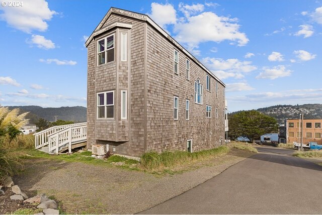 view of side of property with a mountain view