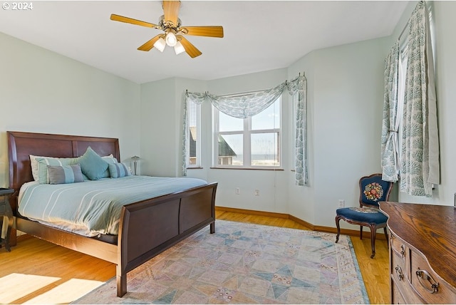 bedroom featuring ceiling fan and light hardwood / wood-style flooring