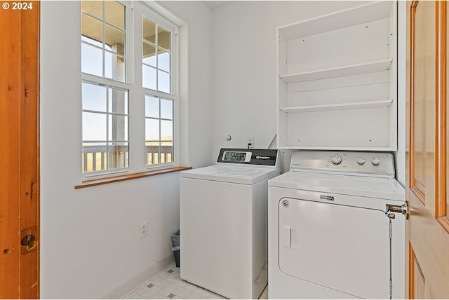 laundry room with separate washer and dryer, laundry area, and baseboards