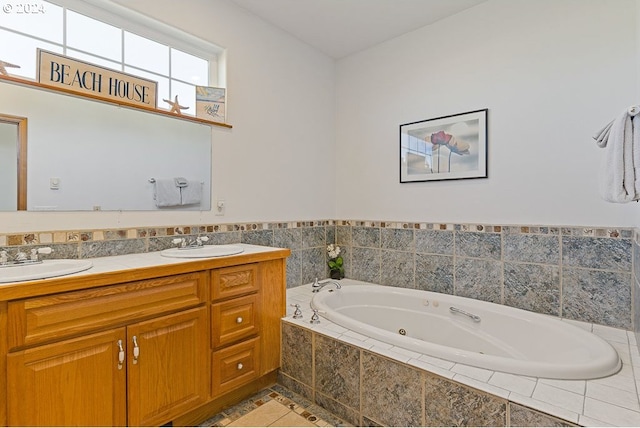 bathroom featuring tiled tub, tile patterned flooring, and vanity