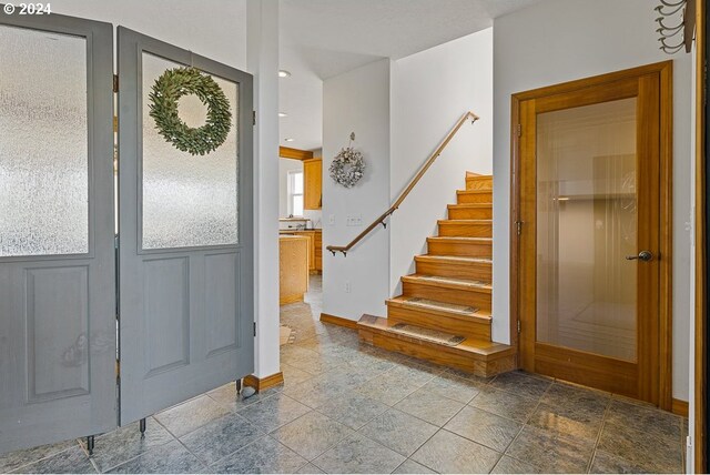 entrance foyer featuring recessed lighting, stairs, and baseboards