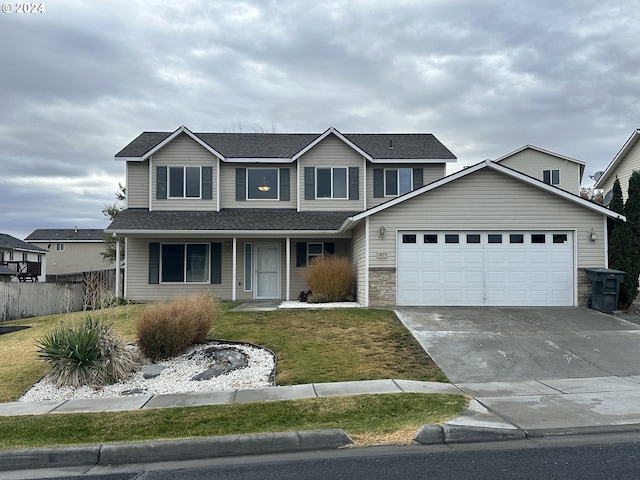 view of property with a garage and a front yard