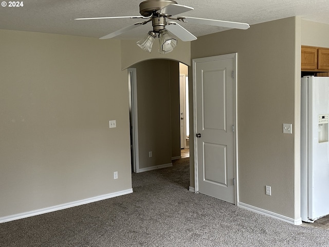 carpeted empty room featuring a textured ceiling and ceiling fan