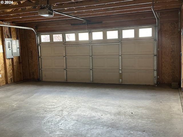 garage featuring electric panel and a garage door opener