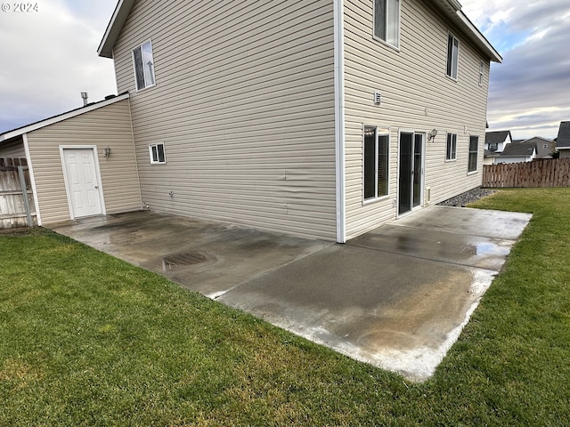 view of home's exterior featuring a patio area and a lawn