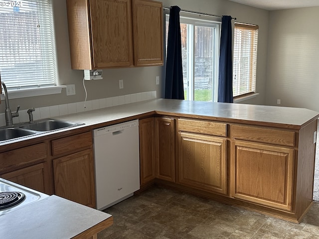 kitchen with kitchen peninsula, sink, and dishwasher