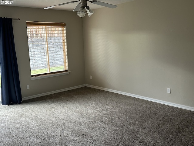 spare room featuring ceiling fan, a healthy amount of sunlight, and carpet