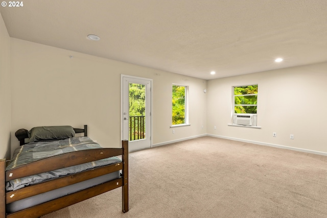 bedroom featuring cooling unit, light colored carpet, and access to exterior