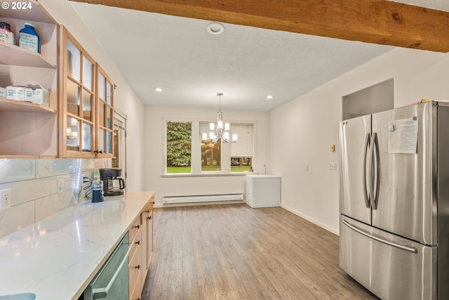 kitchen featuring stainless steel appliances, light hardwood / wood-style floors, light stone counters, hanging light fixtures, and baseboard heating