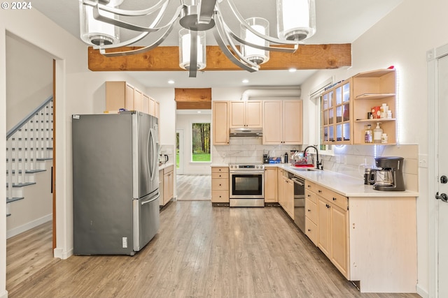 kitchen featuring a chandelier, appliances with stainless steel finishes, decorative backsplash, and light hardwood / wood-style floors