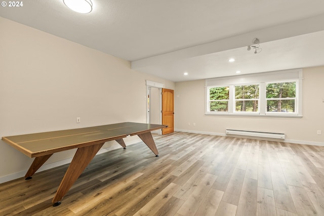 unfurnished dining area with baseboard heating and light hardwood / wood-style flooring