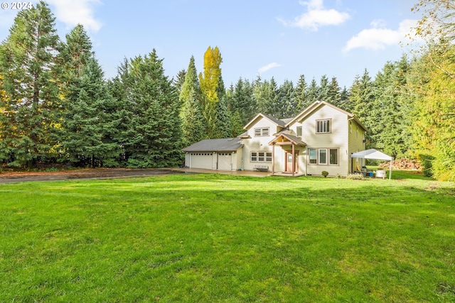 view of front property with a garage and a front yard