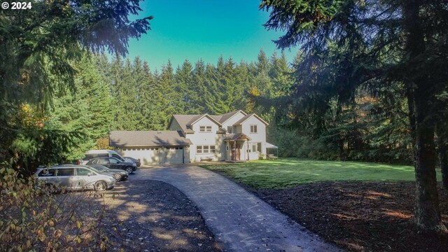 view of front of house with a garage and a front lawn