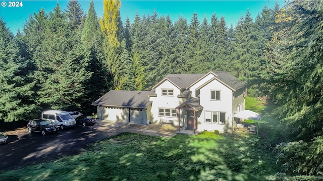 view of front of home featuring a garage and a front yard