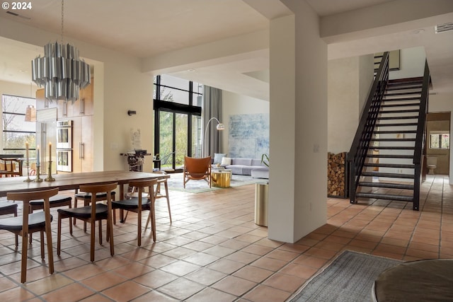 dining room with light tile patterned floors and an inviting chandelier