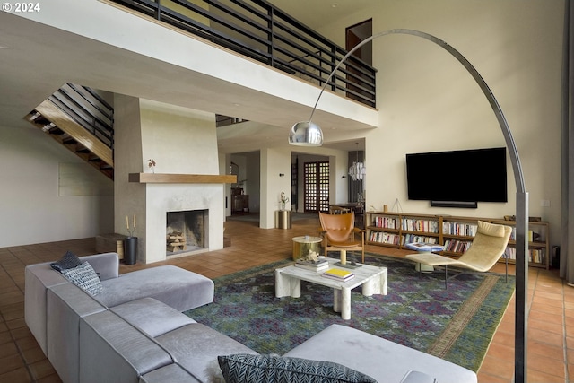 tiled living room featuring a towering ceiling