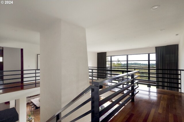 hallway with hardwood / wood-style floors