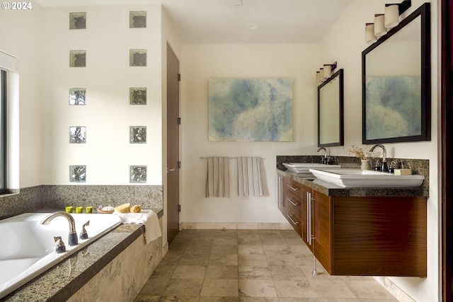 bathroom with vanity and tiled tub