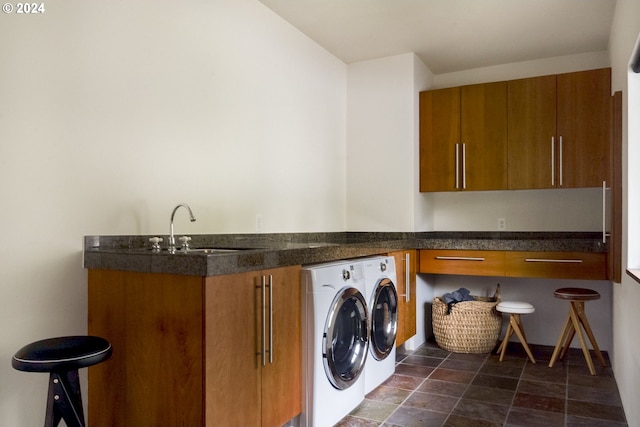 washroom featuring washer and clothes dryer, cabinets, and sink