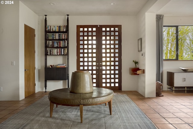 living area with french doors and light tile patterned flooring