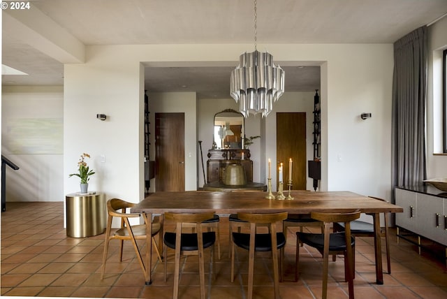 tiled dining space featuring a chandelier