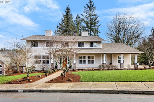 view of front facade with a chimney and a front yard