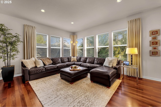 living room with dark wood-type flooring, recessed lighting, and baseboards