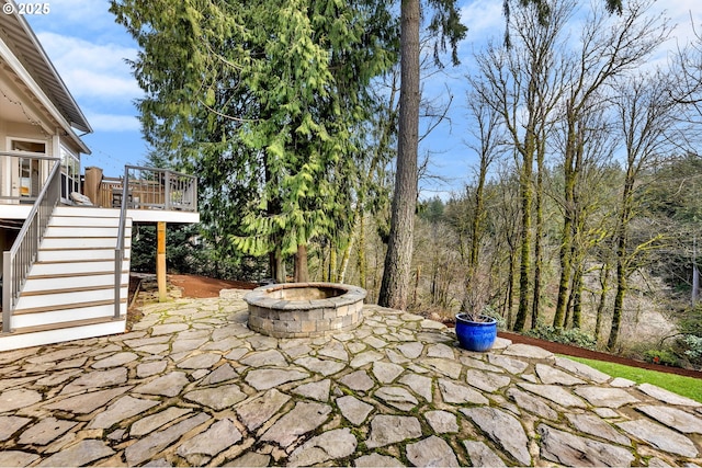 view of patio / terrace featuring a fire pit and stairway