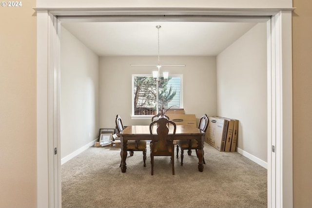 dining area featuring carpet and a chandelier