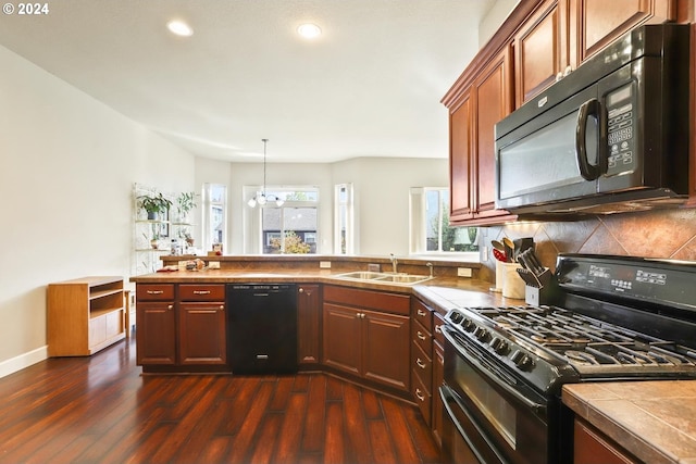 kitchen with dark wood-type flooring, sink, tile countertops, decorative backsplash, and black appliances