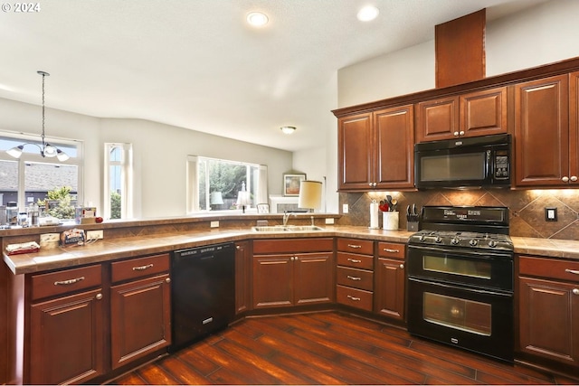 kitchen with sink, backsplash, dark hardwood / wood-style floors, black appliances, and decorative light fixtures