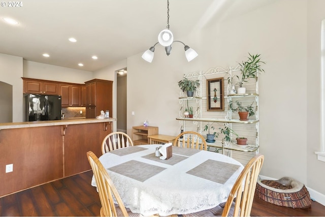 dining room featuring dark hardwood / wood-style floors and a chandelier