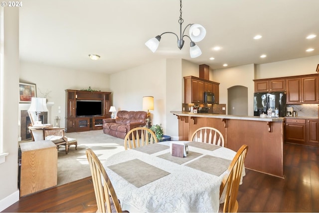 dining area featuring dark hardwood / wood-style floors and a notable chandelier