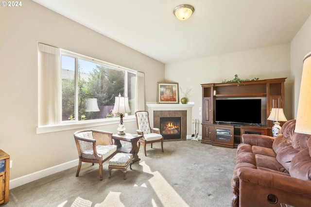 carpeted living room featuring a tile fireplace