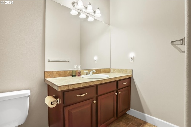 bathroom with vanity, tile patterned floors, and toilet